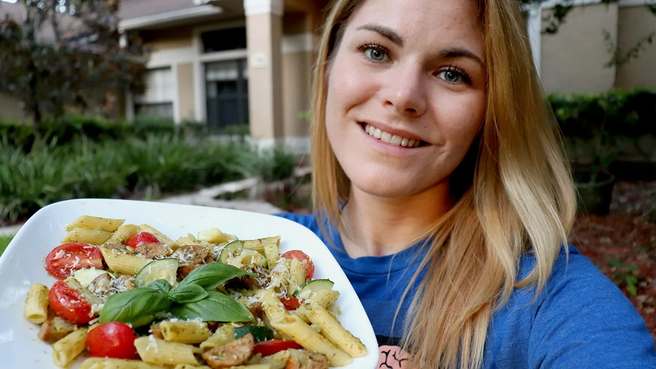 Caitlin Havener holds a Pesto Brown Rice Quinoa Pasta with Italian Chicken Sausage