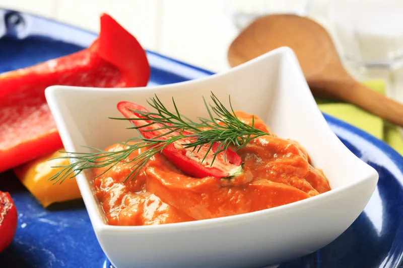 Red pepper coulis in a bowl close up