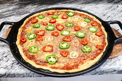Preparing Pineapple Pepper Plant-based Pizza