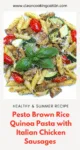 plate of brown pasta with chicken sausages and basilic