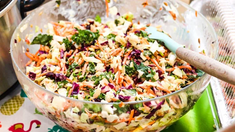 Glass bowl full of kale apple beet coleslaw