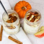 two jars full of overnight oats and pumpkin on the side
