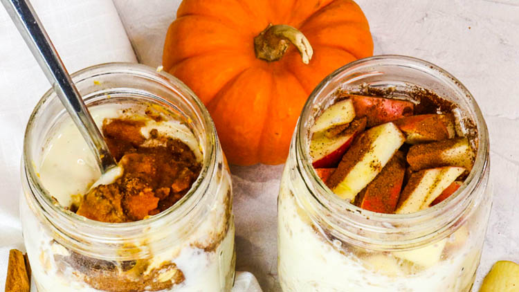 two jars full of overnight oats and pumpkin on the side